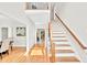 Bright foyer with hardwood floors, staircase and view into other rooms, offering a welcoming entrance at 110 Glenrose Ln, Cary, NC 27518
