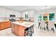 Bright kitchen features a center island with seating, white countertops and modern appliances at 110 Glenrose Ln, Cary, NC 27518