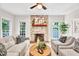 Cozy living room features a stone fireplace, hardwood floors, and lots of natural light at 110 Glenrose Ln, Cary, NC 27518