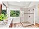 Bright main bathroom features a glass enclosed shower with window providing natural light and an outdoors view at 110 Glenrose Ln, Cary, NC 27518