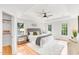 Bright main bedroom suite features tray ceiling, plush rug, king bed, and a view of the outdoors at 110 Glenrose Ln, Cary, NC 27518