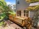 Wooden deck with stairs leading to the landscaped backyard and mature trees at 110 Huntersville Rd, Morrisville, NC 27560