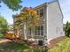 Rear exterior showcasing the two-story home, deck, mature tree and a lush, landscaped yard at 110 Huntersville Rd, Morrisville, NC 27560