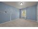 Cozy bedroom with blue walls, white trim, and a decorative tree decal at 110 Huntersville Rd, Morrisville, NC 27560