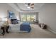 Spacious bedroom with tray ceilings, a ceiling fan, and ample natural light from a large window at 110 Huntersville Rd, Morrisville, NC 27560