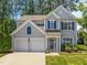 Charming two-story home with blue shutters and a well-manicured front yard, complemented by a two-car garage at 110 Huntersville Rd, Morrisville, NC 27560
