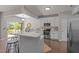 Stylish kitchen with white cabinetry, a large center island, stainless steel appliances, and hardwood floors at 110 Huntersville Rd, Morrisville, NC 27560