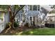 Back patio with seating and lush greenery, creating a relaxing outdoor space at 11013 Louson Pl, Raleigh, NC 27614