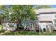Wide view of the backyard with a patio, lawn, and mature trees offering shade at 11013 Louson Pl, Raleigh, NC 27614