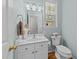 Cozy bathroom with a white vanity, toilet, mirror and natural light from the window at 11013 Louson Pl, Raleigh, NC 27614