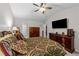 Spacious bedroom with a decorative bed, ceiling fan, TV and ample storage space at 11013 Louson Pl, Raleigh, NC 27614