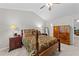 Bedroom showcasing a decorative four-poster bed, ceiling fan, and coordinated furniture at 11013 Louson Pl, Raleigh, NC 27614