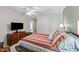 Comfortable bedroom featuring a bed, a ceiling fan, a dresser and neutral walls at 11013 Louson Pl, Raleigh, NC 27614