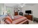 Spacious bedroom featuring a large bed, a ceiling fan and natural light from the windows at 11013 Louson Pl, Raleigh, NC 27614