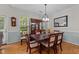 Bright dining room featuring hardwood floors, a large china cabinet, and natural light at 11013 Louson Pl, Raleigh, NC 27614
