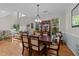 Spacious dining room featuring hardwood floors, a china cabinet, and adjoining living space at 11013 Louson Pl, Raleigh, NC 27614