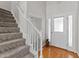 Traditional entryway featuring hardwood floors, a decorative front door, and staircase at 11013 Louson Pl, Raleigh, NC 27614