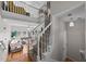 Bright entryway with hardwood floors, a staircase with white railings, and a view of the living room at 11013 Louson Pl, Raleigh, NC 27614