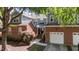 A brick and siding exterior with a one-car garage create a charming facade, enhanced by the landscaped front yard at 11013 Louson Pl, Raleigh, NC 27614