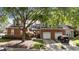 Beautiful home with brick accents, a driveway, mature trees, and well-maintained landscaping at 11013 Louson Pl, Raleigh, NC 27614