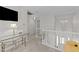 Bright hallway with white railings, neutral carpeting, and a decorative chandelier over the front door at 11013 Louson Pl, Raleigh, NC 27614