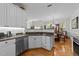 Kitchen view showing stainless steel dishwasher and sink, granite counter tops and open plan at 11013 Louson Pl, Raleigh, NC 27614