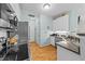Well-organized kitchen with stainless steel appliances, granite countertops, and hardwood floors at 11013 Louson Pl, Raleigh, NC 27614