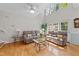 Sunlit living room featuring high ceilings, hardwood floors, and neutral-toned furniture at 11013 Louson Pl, Raleigh, NC 27614