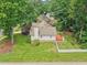 Aerial view displays a home with a charming red patio, white picket fence, and lush green yard at 1102 Laurens Way, Knightdale, NC 27545