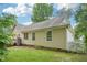 The backyard showcases the home's exterior, with a view of the yard, greenery, and partial deck at 1102 Laurens Way, Knightdale, NC 27545