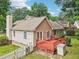 Exterior view features a home with a charming red patio, white picket fence, and lush green yard at 1102 Laurens Way, Knightdale, NC 27545
