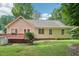 Back exterior view of the home with a spacious wooden deck and a well-maintained lawn at 1102 Laurens Way, Knightdale, NC 27545