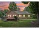 Cozy home featuring a backyard with a wooden deck and a lush green lawn at 1102 Laurens Way, Knightdale, NC 27545