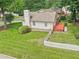 Aerial view displays a home with a charming red patio, white picket fence, and lush green yard at 1102 Laurens Way, Knightdale, NC 27545