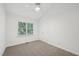 Bright bedroom boasts plush carpet, neutral walls and a large window at 1102 Laurens Way, Knightdale, NC 27545