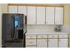 This kitchen offers white cabinets, a black fridge and matching countertops at 1102 Laurens Way, Knightdale, NC 27545