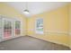 Bright living room features yellow walls, neutral carpeting and outdoor access at 1102 Laurens Way, Knightdale, NC 27545