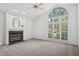 Bright living room featuring a fireplace and large window, offering a spacious and airy feel at 1102 Laurens Way, Knightdale, NC 27545