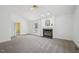 Bright living room featuring a fireplace and large window, offering a spacious and airy feel at 1102 Laurens Way, Knightdale, NC 27545