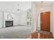 Bright living room featuring a fireplace and large window, blending carpeted and hardwood floors at 1102 Laurens Way, Knightdale, NC 27545
