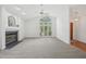 Bright living room featuring a fireplace and large window, offering a spacious and airy feel at 1102 Laurens Way, Knightdale, NC 27545