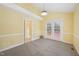 Bright living room features yellow walls, neutral carpeting and outdoor access at 1102 Laurens Way, Knightdale, NC 27545