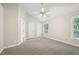 Vaulted main bedroom features neutral walls, plush carpeting and ceiling fan at 1102 Laurens Way, Knightdale, NC 27545