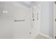 Roll-in shower features a shower head, grab bars and tiled walls at 1102 Laurens Way, Knightdale, NC 27545