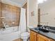 Well-lit bathroom features a granite countertop, a tub, and tasteful brown tiled wall at 111 Finsbury Street St, Durham, NC 27703