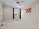 Bright bedroom featuring neutral walls, a ceiling fan, and a large window at 111 Finsbury Street St, Durham, NC 27703