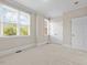 Bedroom with neutral carpet, two windows, and white trim at 111 Finsbury Street St, Durham, NC 27703