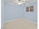 Light blue bedroom with a ceiling fan and bright window at 111 Finsbury Street St, Durham, NC 27703