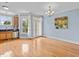 Dining space with hardwood floors, chandelier, and adjacent kitchen area at 111 Finsbury Street St, Durham, NC 27703