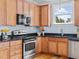 Cozy kitchen featuring stainless steel appliances, wooden cabinets, and granite countertops at 111 Finsbury Street St, Durham, NC 27703